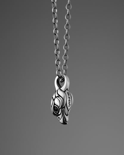 Sterling silver necklace with a small falcon pendant on a gray background