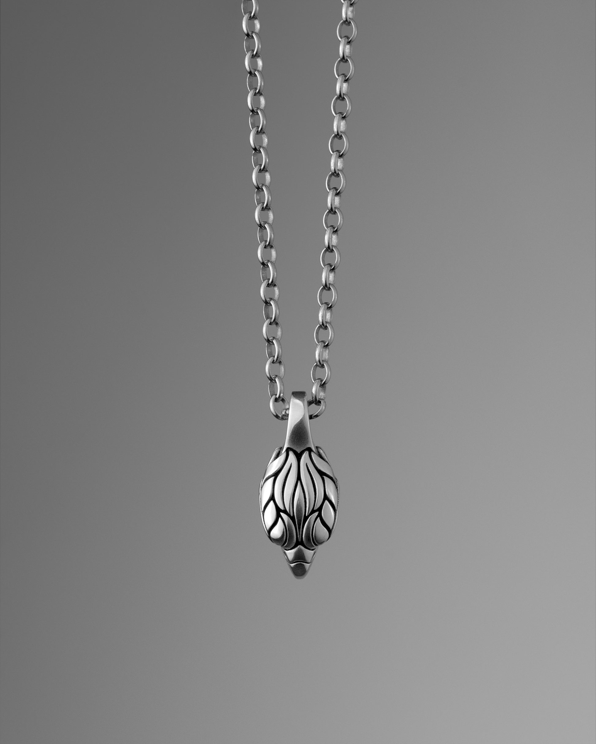 Front view of a silver falcon head pendant, hanging from a rolo chain.