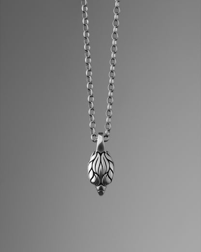Front view of a silver falcon head pendant, hanging from a rolo chain.