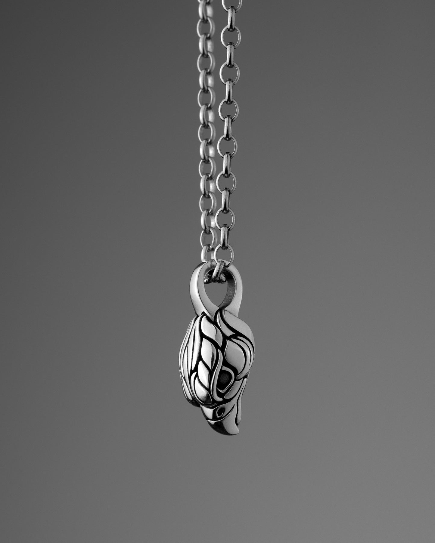 Silver Falcon (Hawk) Head pendant necklace on a gray background