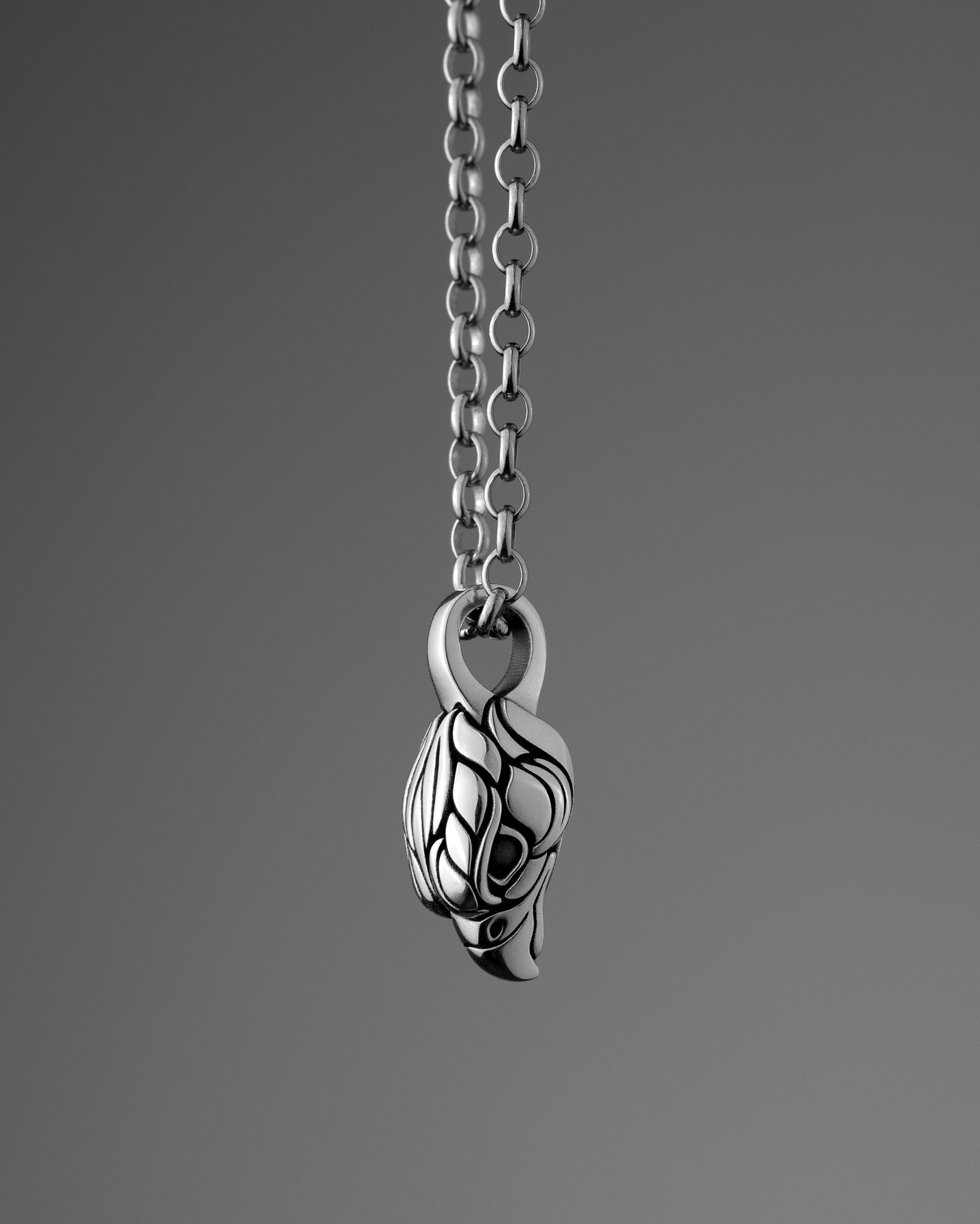 Silver Falcon (Hawk) Head pendant necklace on a gray background