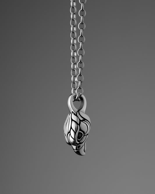 Silver Falcon (Hawk) Head pendant necklace on a gray background