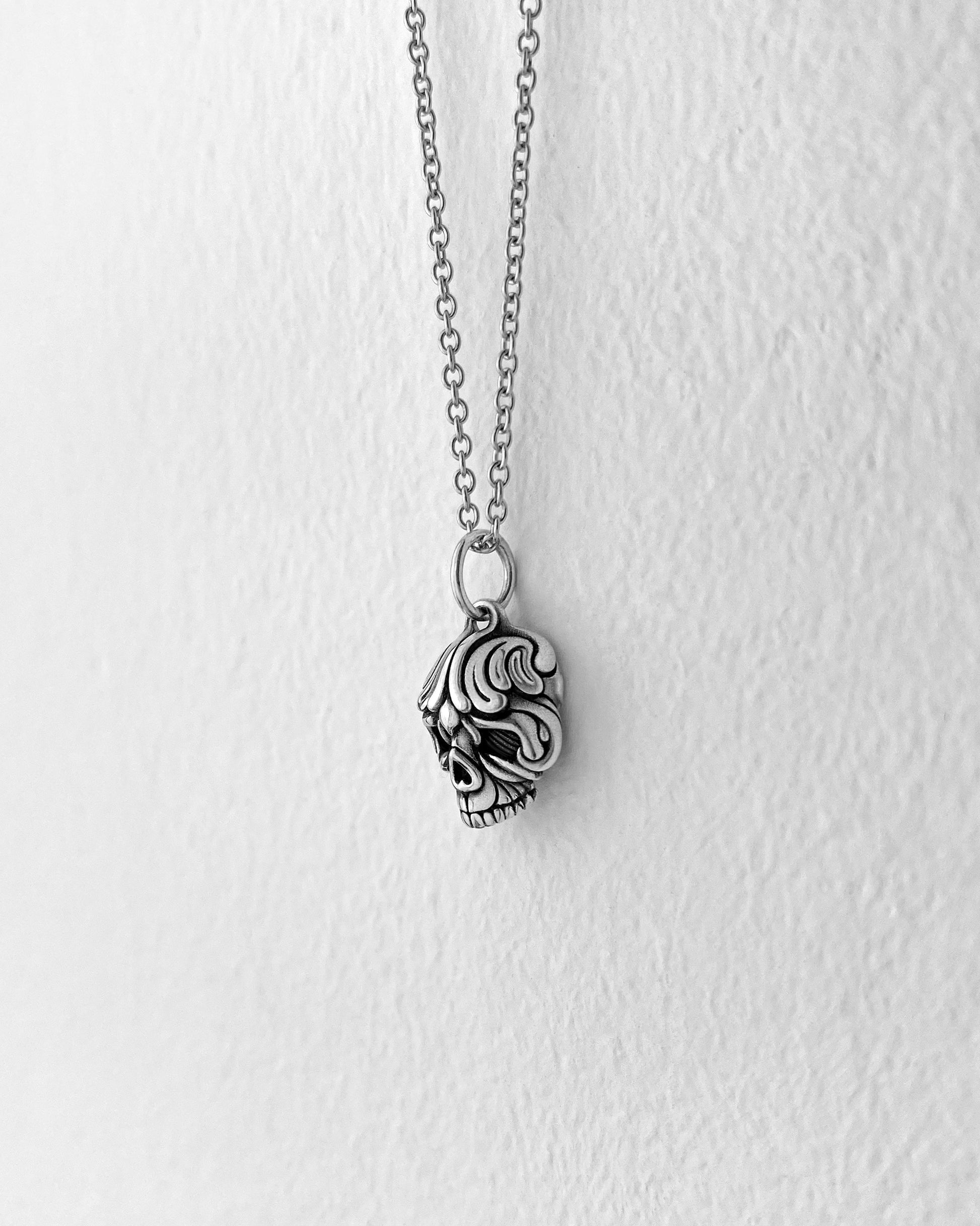 Baroque scrollwork inspired small silver Skull pendant