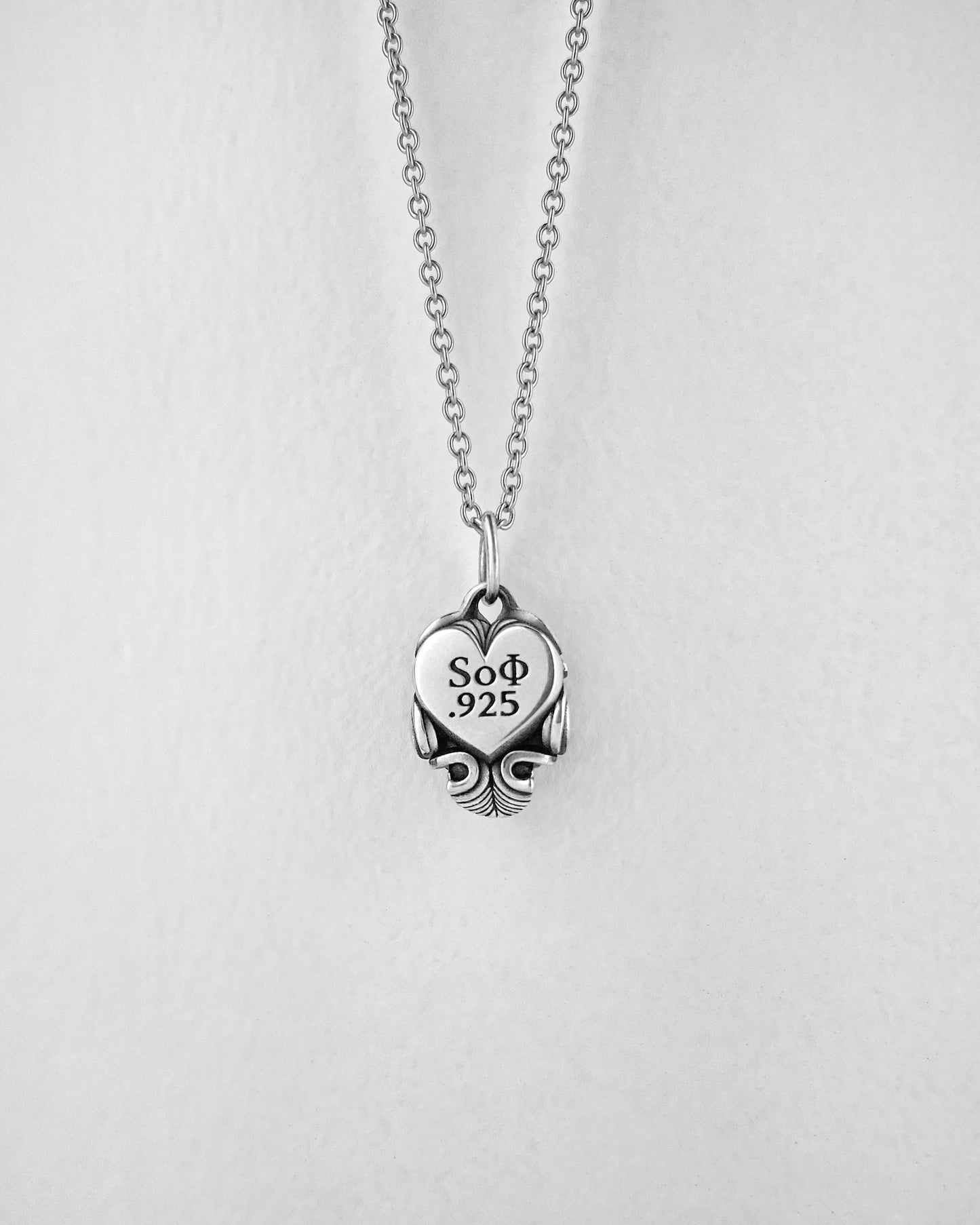 Small Silver Skull pendant with heart on the back