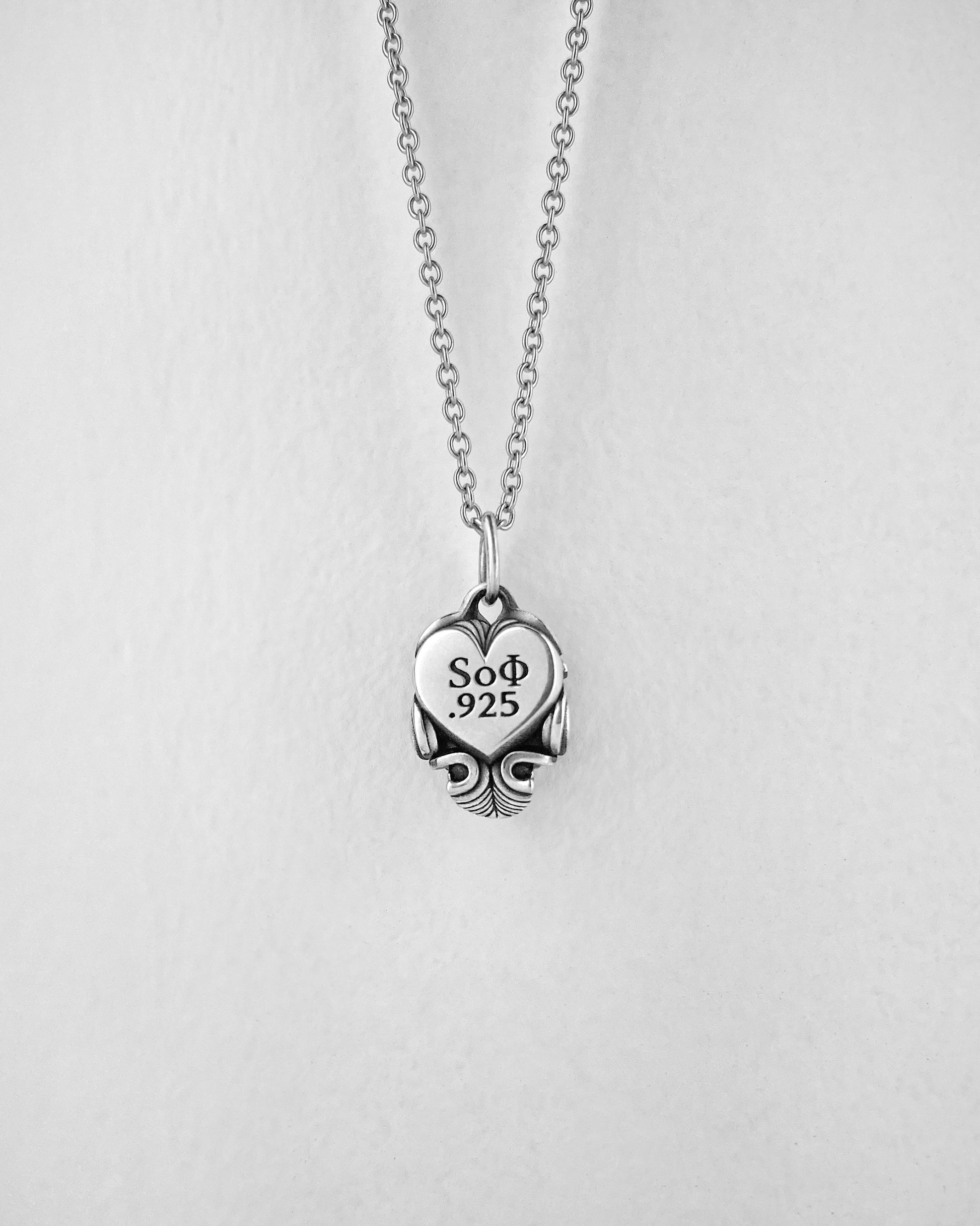 Small Silver Skull pendant with heart on the back