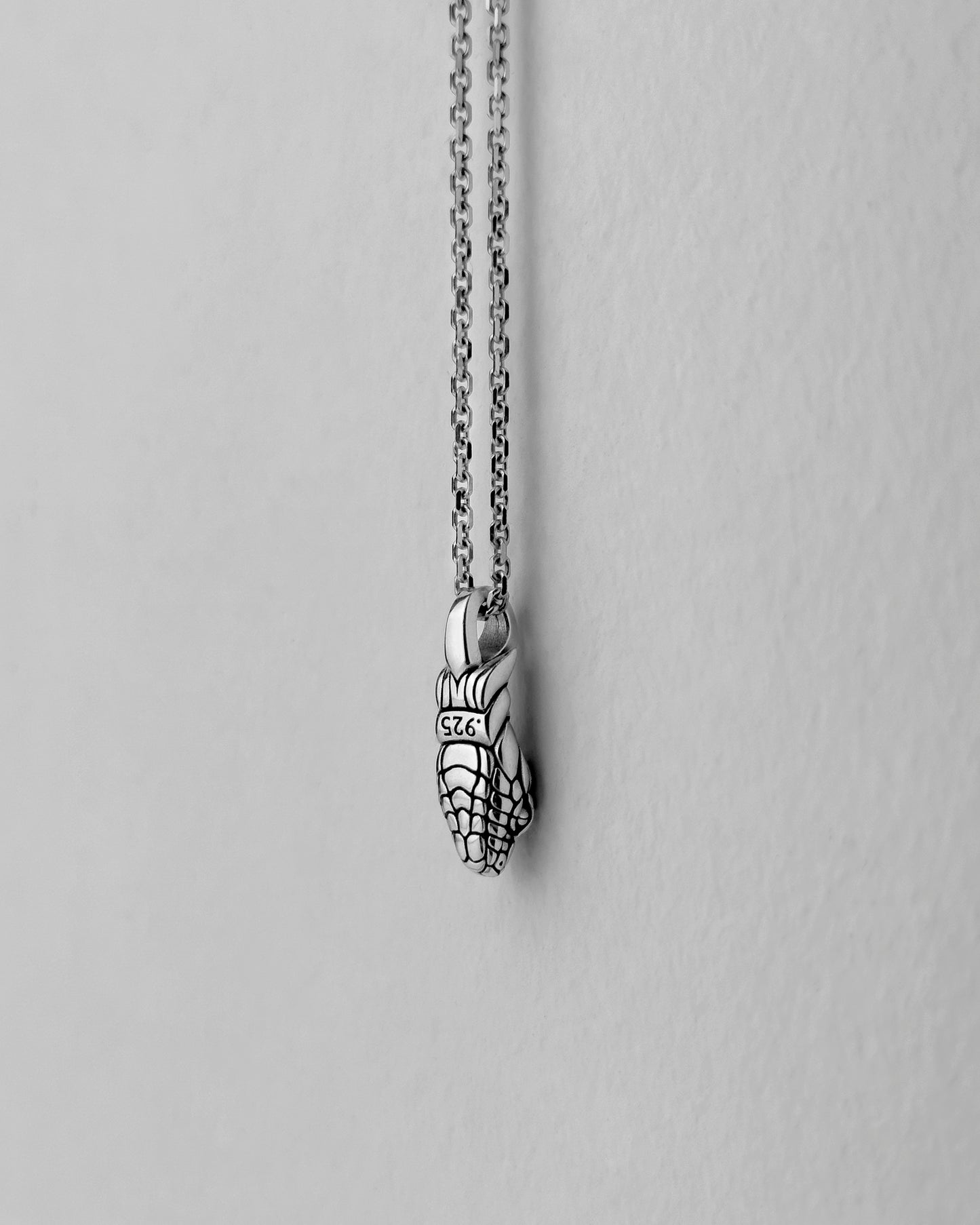 Back view of a silver snake pendant